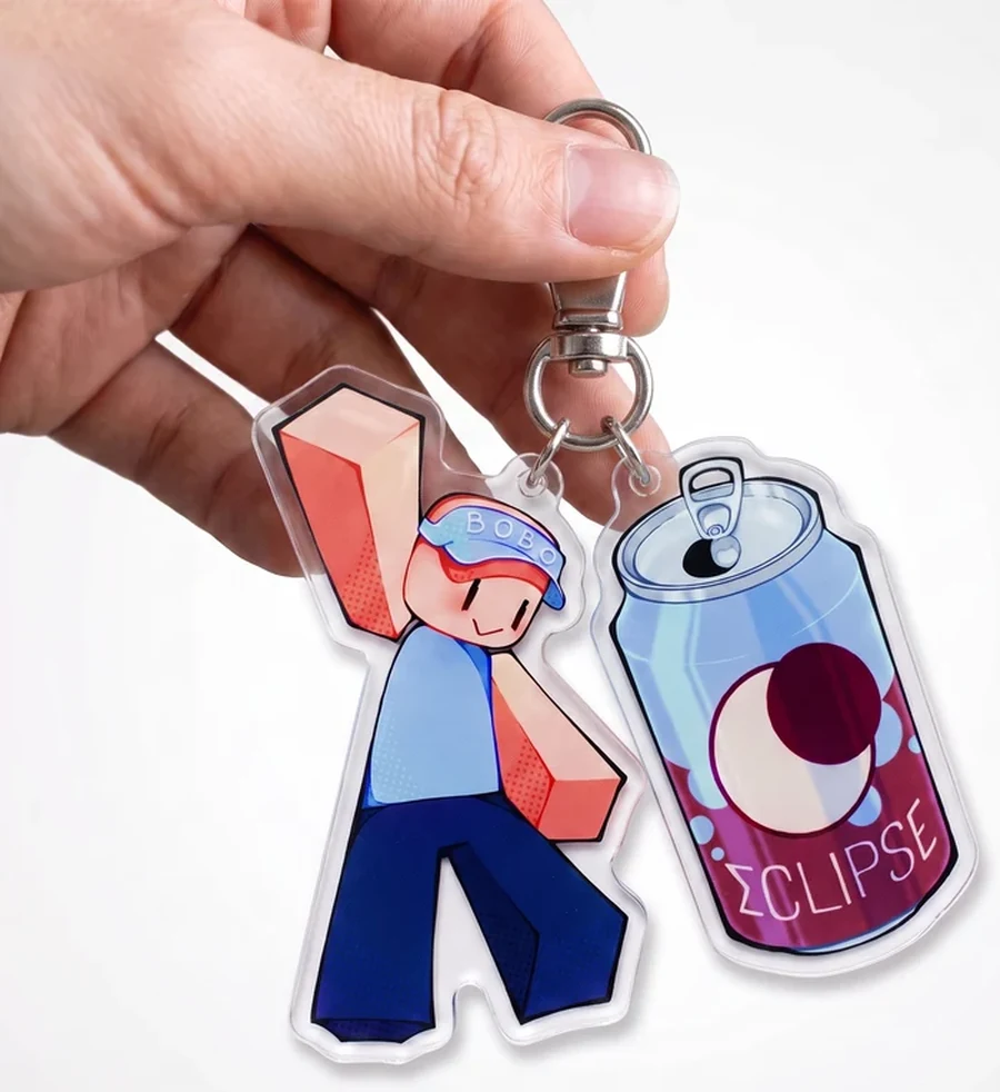 Both keychains held in one hand, showing their scale